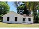 Charming white home featuring black-trim windows, lovely landscaping, and a welcoming front entrance at 7774 Ginger Ln, North Charleston, SC 29420