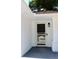 Welcoming front entrance with a secure screen door and a modern exterior light fixture at 7774 Ginger Ln, North Charleston, SC 29420