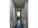 Bright hallway featuring hardwood floors and white trim, leading to various rooms at 7774 Ginger Ln, North Charleston, SC 29420