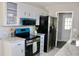 Charming kitchen featuring stainless steel refrigerator, new range, granite countertops, and refinished cabinets at 7774 Ginger Ln, North Charleston, SC 29420