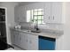 Updated kitchen with stainless steel sink, granite countertops, refinished cabinets, and modern fixtures at 7774 Ginger Ln, North Charleston, SC 29420