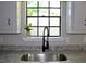 A lovely black faucet over a stainless steel sink looks out on a big window at 7774 Ginger Ln, North Charleston, SC 29420