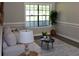 Bright living room with large window, stylish rug, and comfortable seating area at 7774 Ginger Ln, North Charleston, SC 29420