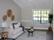 Bright living room featuring a stylish couch, decorative wall art, and an inviting area rug at 7774 Ginger Ln, North Charleston, SC 29420