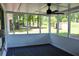 Screened porch with a ceiling fan and a view of the trees and shed at 7774 Ginger Ln, North Charleston, SC 29420