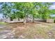 View of a large backyard with mature trees and a storage shed at 7869 High Maple Cir, North Charleston, SC 29418