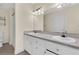 Bathroom featuring double sinks, white cabinets, large mirror and updated light fixture at 7869 High Maple Cir, North Charleston, SC 29418