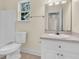 Bright bathroom with a single sink vanity, tub-shower combo and a window at 7869 High Maple Cir, North Charleston, SC 29418