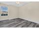 Spacious bedroom with grey wood flooring and a large window at 7869 High Maple Cir, North Charleston, SC 29418