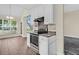 Modern kitchen with stainless steel appliances, white cabinets, and open access to the dining area at 7869 High Maple Cir, North Charleston, SC 29418