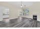 Bright, open living room with fireplace, large windows, and views of the kitchen and dining areas at 7869 High Maple Cir, North Charleston, SC 29418