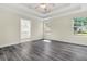 Empty main bedroom showcasing spacious layout, stylish flooring, and ensuite access for added convenience at 7869 High Maple Cir, North Charleston, SC 29418