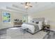 Serene main bedroom with tray ceilings, two windows, and a neutral palette for a relaxing atmosphere at 7869 High Maple Cir, North Charleston, SC 29418