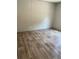 Clean, empty bedroom showcasing wood-look floors, neutral walls, and a simple, functional design at 852 Lawyer Ln, Cross, SC 29436
