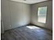 Bedroom featuring durable wood-look floors, paneled walls, and a window that offers plenty of natural light at 852 Lawyer Ln, Cross, SC 29436