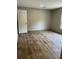 Bright bedroom with wood-look floors, fresh paint, and natural light; door ajar at 852 Lawyer Ln, Cross, SC 29436