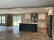 Open concept kitchen featuring an island with sink, white cabinets, and stainless steel appliances at 852 Lawyer Ln, Cross, SC 29436