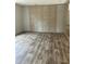 Spacious living room featuring light wood-look vinyl flooring and a light wood accent wall at 852 Lawyer Ln, Cross, SC 29436