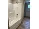 Bathroom featuring a shower-tub combination and hard surface floors, and a glimpse of a walk-in closet at 846 Lawyer Ln, Cross, SC 29436