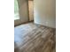 Bright bedroom featuring stylish wood-look floors, neutral paint, and a window letting in natural light at 846 Lawyer Ln, Cross, SC 29436