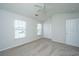 Bright bedroom with neutral carpet, ceiling fan, two windows, and closet at 9098 Maple Grove Dr, Summerville, SC 29485