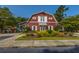 Picturesque red clubhouse with white trim, surrounded by lush landscaping at 9098 Maple Grove Dr, Summerville, SC 29485