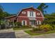 Attractive red clubhouse with a welcoming entrance and vibrant floral landscaping at 9098 Maple Grove Dr, Summerville, SC 29485