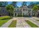 Charming two-story townhome showcasing manicured landscaping and a paved driveway at 9098 Maple Grove Dr, Summerville, SC 29485