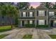 Two-story condo features symmetrical windows, black shutters, and a well-manicured lawn at 9098 Maple Grove Dr, Summerville, SC 29485