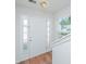 Bright foyer featuring a white front door flanked by sidelights and wood-look flooring at 9098 Maple Grove Dr, Summerville, SC 29485