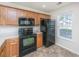Updated kitchen with modern appliances, including a black fridge and electric range at 9098 Maple Grove Dr, Summerville, SC 29485