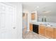 Cozy kitchen with ample cabinet space and tile floor with view to the living room at 9098 Maple Grove Dr, Summerville, SC 29485