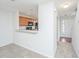 Open-concept view of the kitchen and entry, with a breakfast bar and wood cabinets at 9098 Maple Grove Dr, Summerville, SC 29485