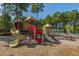 Colorful playground with slides, climbing structures and picnic tables nearby at 9098 Maple Grove Dr, Summerville, SC 29485