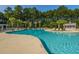 Large outdoor pool surrounded by lounge chairs and lush greenery for relaxation at 9098 Maple Grove Dr, Summerville, SC 29485