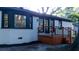 Charming white brick home with black trim, and a beautifully finished wood back deck and black metal railing at 10 Bayshore Blvd, Goose Creek, SC 29445