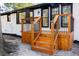 A well-crafted back deck featuring wood stairs, black metal railings, and white painted brick exterior at 10 Bayshore Blvd, Goose Creek, SC 29445