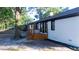 Rear view of white brick home with a wooden deck and black trimmed windows at 10 Bayshore Blvd, Goose Creek, SC 29445