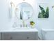 Elegant bathroom featuring modern vanity, gold fixtures, round mirror and decorative tropical print at 10 Bayshore Blvd, Goose Creek, SC 29445