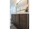 Bathroom vanity features a dark wood cabinet with a stone countertop, a gold faucet, and an ornate mirror at 10 Bayshore Blvd, Goose Creek, SC 29445