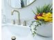 Bathroom sink featuring a golden faucet and decorative plants at 10 Bayshore Blvd, Goose Creek, SC 29445