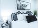 Bright bedroom featuring stylish bed, a unique headboard, and modern black and white artwork at 10 Bayshore Blvd, Goose Creek, SC 29445