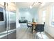 Bright dining room featuring a round table with wood grain finish and stainless fridge at 10 Bayshore Blvd, Goose Creek, SC 29445