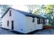 A white brick house with a black roof and trim, featuring a new deck at 10 Bayshore Blvd, Goose Creek, SC 29445