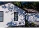 Exterior view of a renovated white brick home with black trim, well manicured landscaping, and a two car garage at 10 Bayshore Blvd, Goose Creek, SC 29445