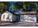 Charming exterior of a white brick house, featuring a two-car garage and manicured landscaping at 10 Bayshore Blvd, Goose Creek, SC 29445