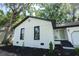 Charming white brick home with black accents, a front door, and updated landscaping at 10 Bayshore Blvd, Goose Creek, SC 29445