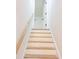 Bright white staircase with natural wood treads and handrail leading to an open doorway at 10 Bayshore Blvd, Goose Creek, SC 29445