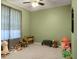 Green bedroom filled with toys, wooden furniture, and natural light at 1026 Briar Rose Ln, Ladson, SC 29456