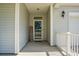 Welcoming covered front porch with a 'Home Sweet Home' sign and a view into the home at 1026 Briar Rose Ln, Ladson, SC 29456